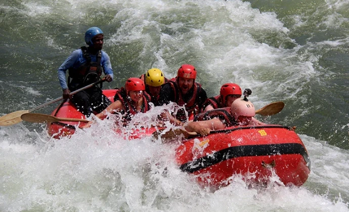 A group of people during white water rafting in Jinja